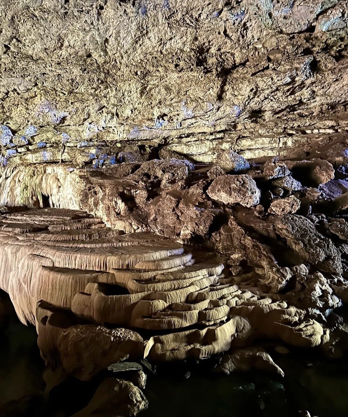 Adventurers swimming into the entrance of the ATM Cave Tour in Belize's jungle
