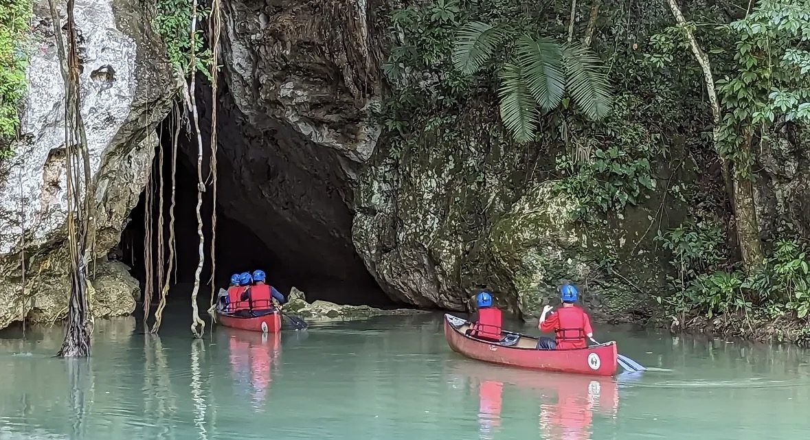 Licensed ATM Cave Tour guide briefing visitors at the cave entrance in Belize